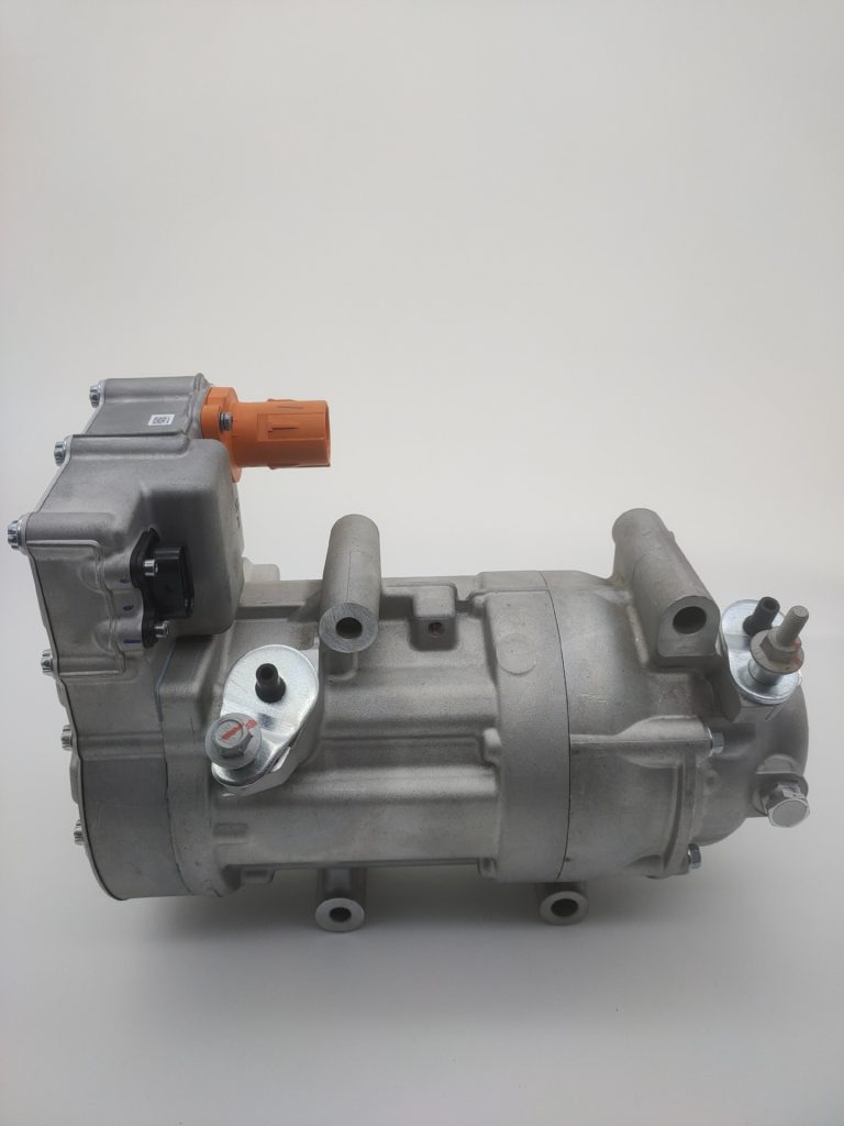 Electric vehicle air-conditioning compressor with compact silver housing and orange connector